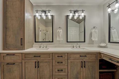 a bathroom with a double vanity sink and a mirror