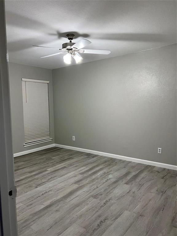 12830 Midway Road, Unit 1129 Dallas, TX 75244 - Photo 12 of 18 a view of an empty room with wooden floor