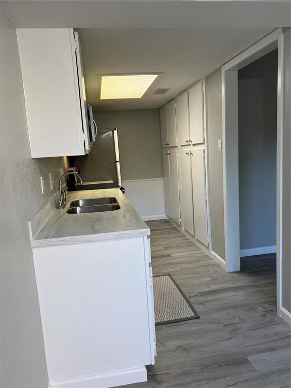 12830 Midway Road, Unit 1129 Dallas, TX 75244 - Photo 7 of 18 a view of kitchen island wooden floor and window