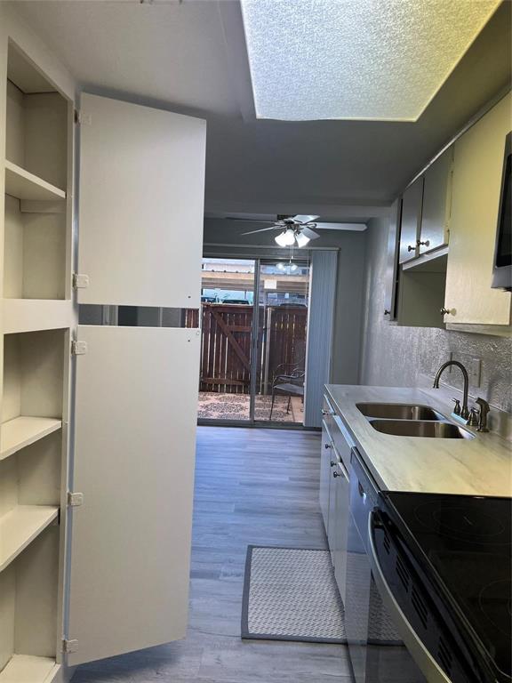 12830 Midway Road, Unit 1129 Dallas, TX 75244 - Photo 8 of 18 a kitchen with a sink and a refrigerator