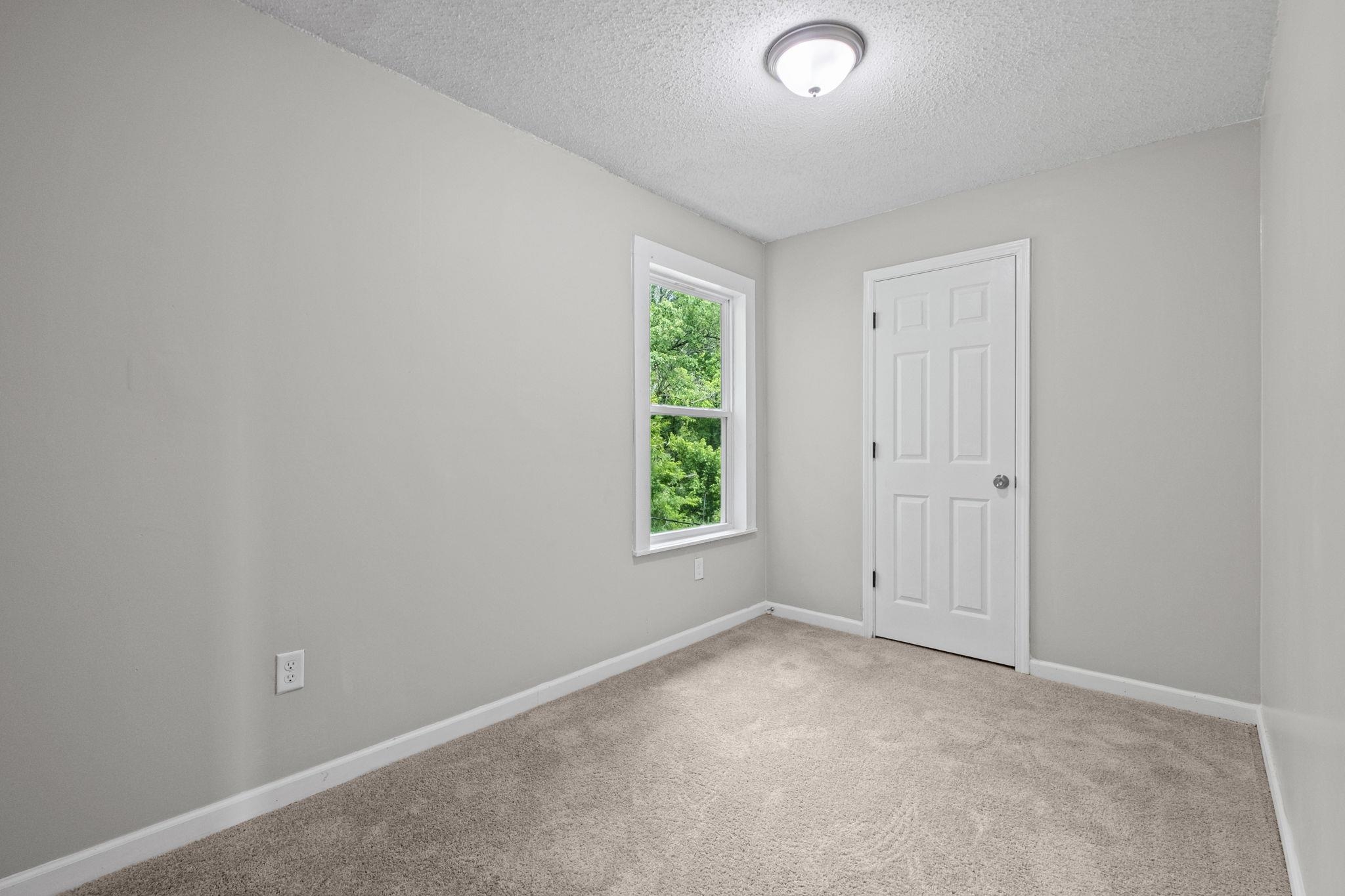 5843 Stewart Road Lakeland, TN 38002 - Photo 22 of 26 Neutral wall paint and carpeting throughout