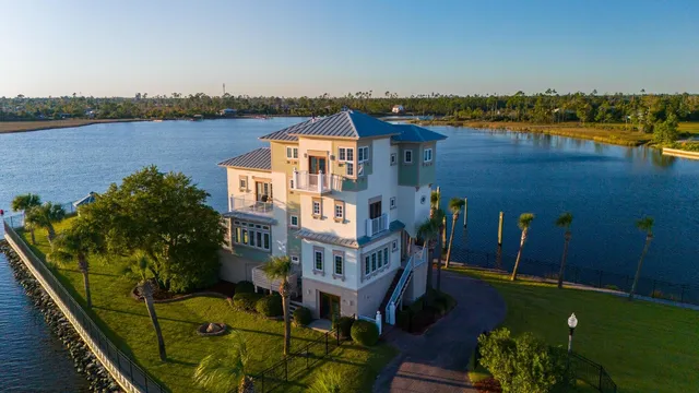 a view of a balcony with lake view and houses in the back