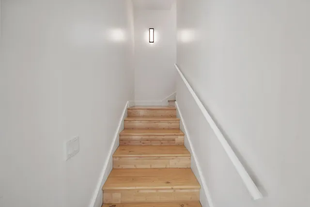 a view of a livingroom with wooden floor and bookshelf