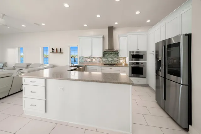 a living room with furniture a flat screen tv and fireplace