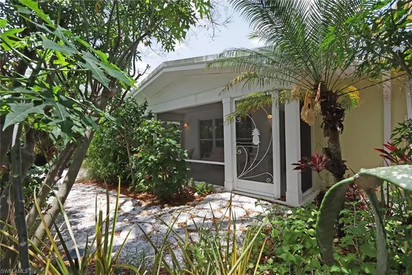 a view of a house with a tree