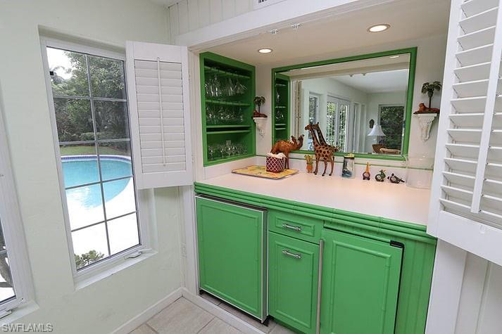 361 1st Avenue North Naples, FL 34102 - Photo 13 of 31 a bathroom with a sink a mirror and next to a window