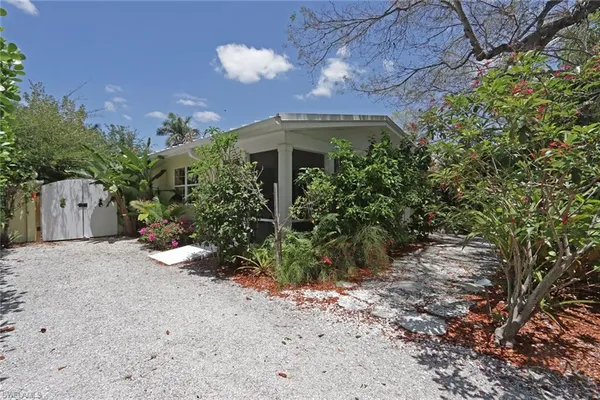 a front view of a house with a yard and a garage