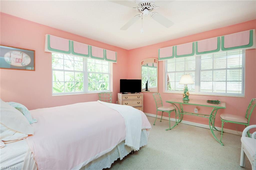 361 1st Avenue North Naples, FL 34102 - Photo 22 of 31 a bedroom with a bed and a chair