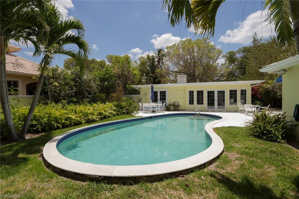 361 1st Avenue North Naples, FL 34102 - Photo 30 of 31 a view of a swimming pool with back yard