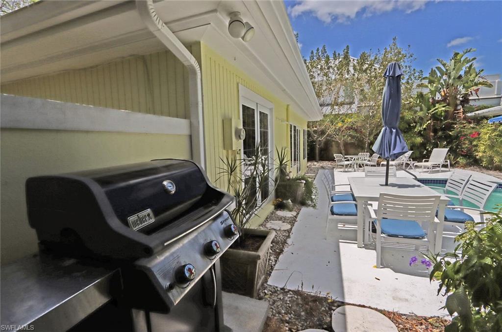 361 1st Avenue North Naples, FL 34102 - Photo 31 of 31 a view of a patio with couches table and chairs and potted plants