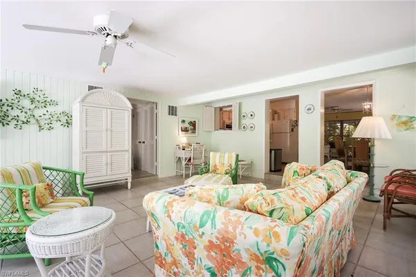 a bedroom with a bed a couch and potted plant