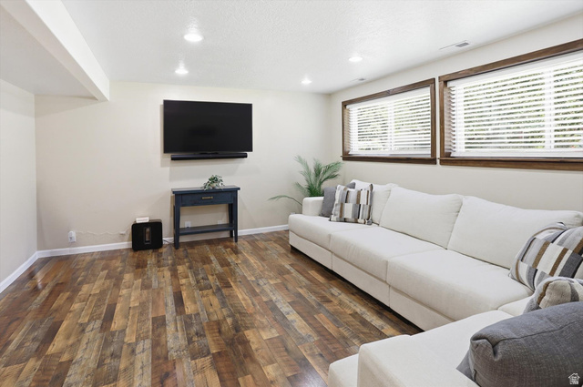 8938 Manchester Lane Sandy, UT 84093 - Photo 24 of 50 Spacious room featuring wood-finish flooring, recessed lighting, and two windows with white blinds and dark wood trim