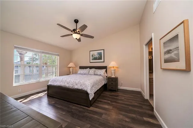 a spacious bedroom with a bed and a large window