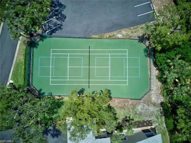 a view of a living room with a white bed