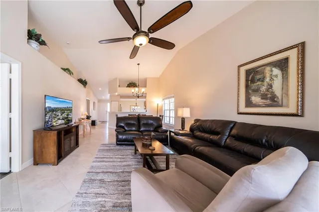 a living room with furniture ceiling fan and a rug