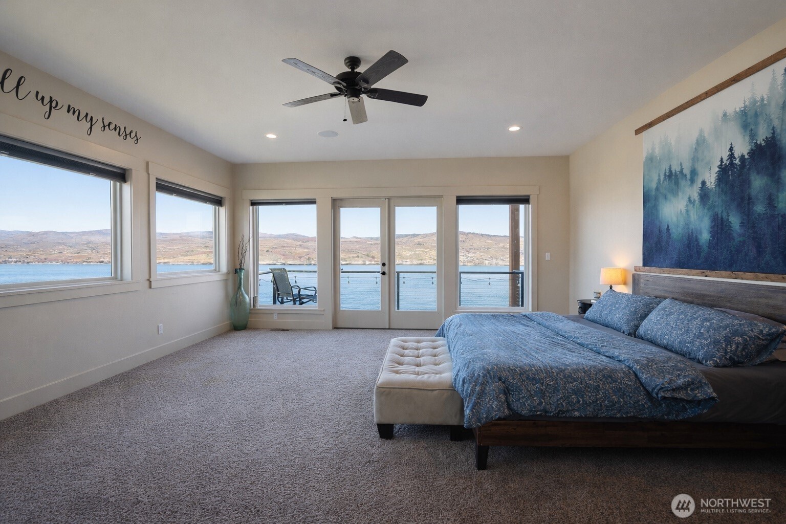 149 Clos Chevalle Road Chelan, WA 98816 - Photo 15 of 37 a spacious bedroom with a large bed and a large window