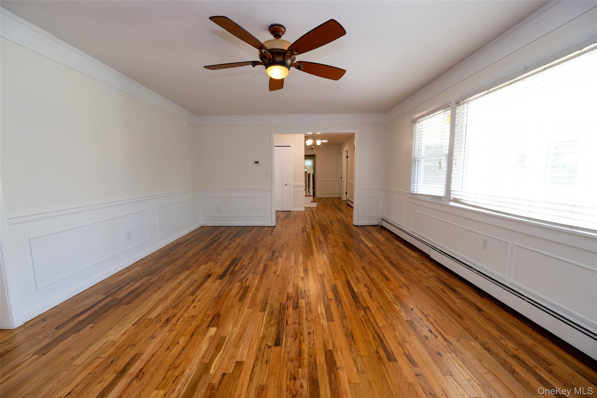 136 Foggintown Road Brewster, NY 10509 - Photo 20 of 50 a view of a room with wooden floor a ceiling fan and windows
