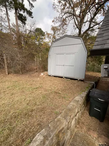 a view of backyard with large trees
