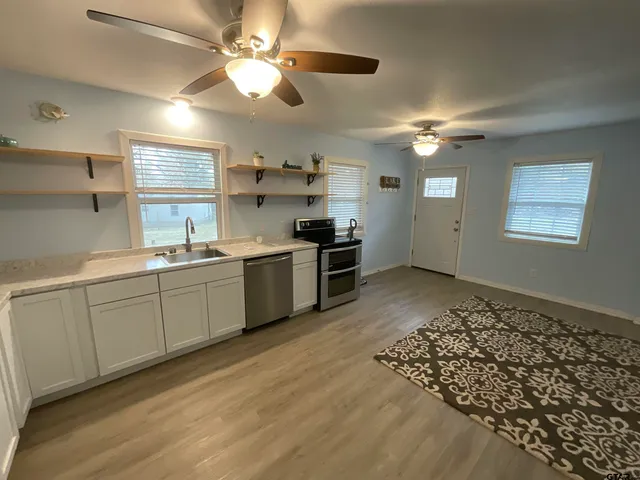 a kitchen with a stove a sink and a refrigerator