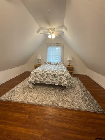 a bedroom with a bed and a night stand