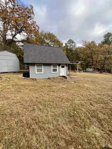a house with trees in the background