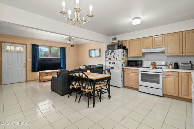 a kitchen with cabinets and chairs
