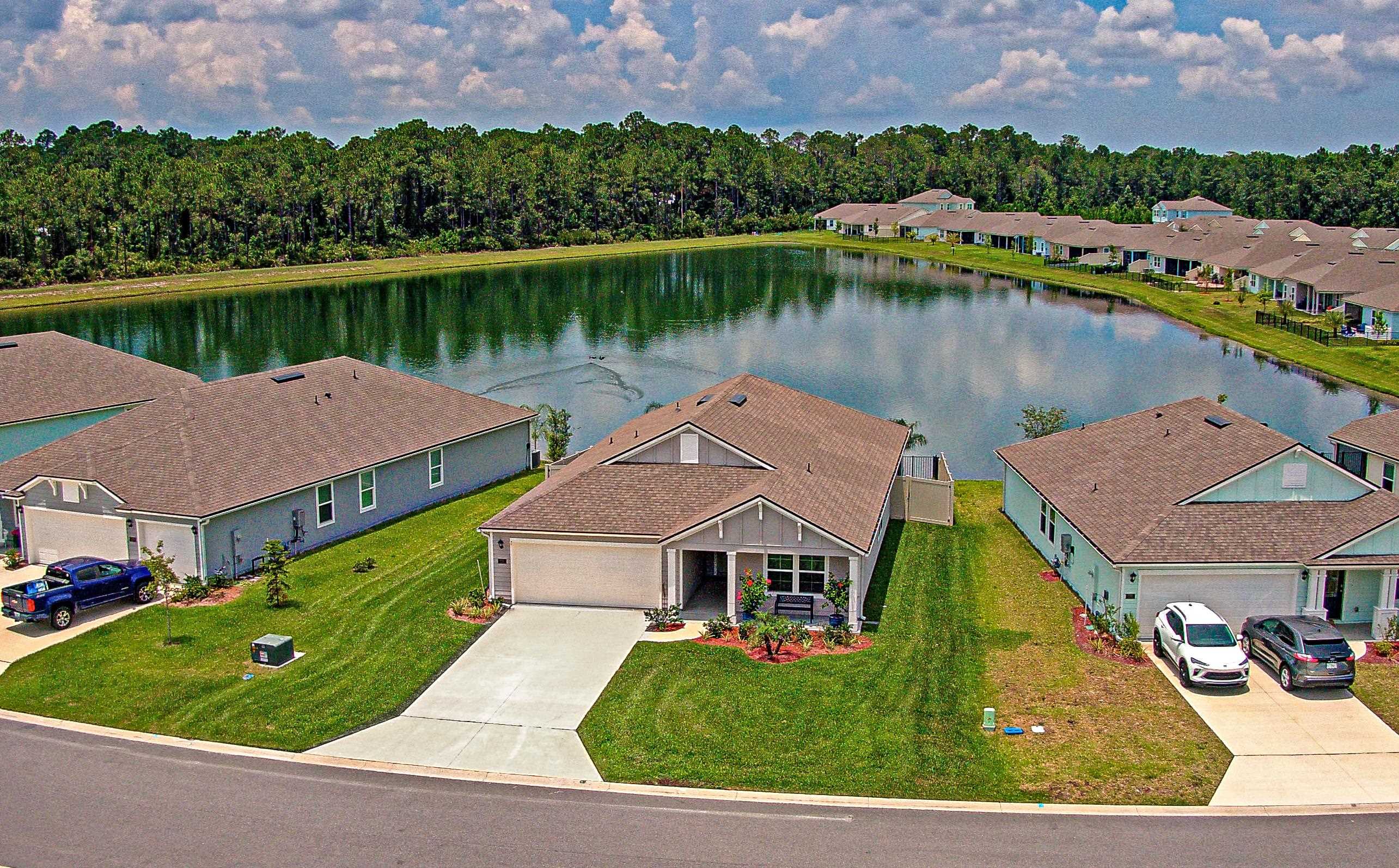 an aerial view of a house with a lake view