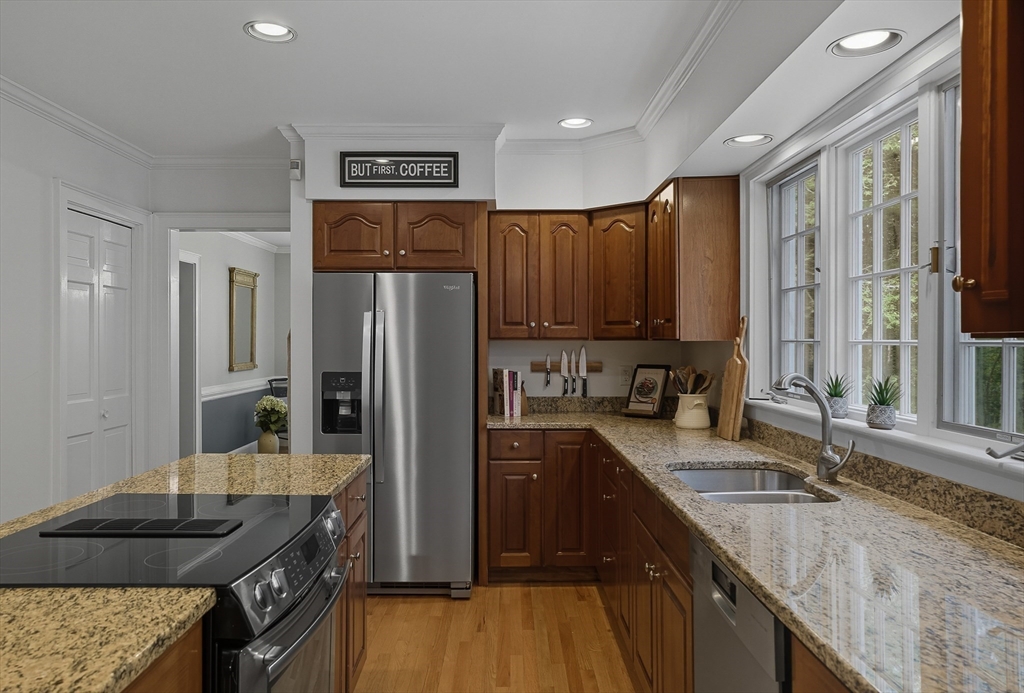 16 Priest Road Berlin, MA 01503 - Photo 11 of 42 a kitchen with granite countertop kitchen island stainless steel appliances a sink stove and refrigerator