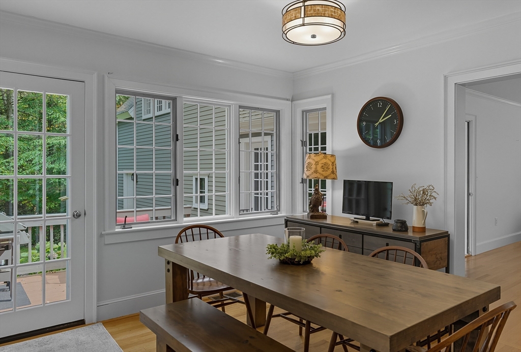 16 Priest Road Berlin, MA 01503 - Photo 13 of 42 a view of kitchen island with granite countertop a stove a sink and a dining table with wooden floor