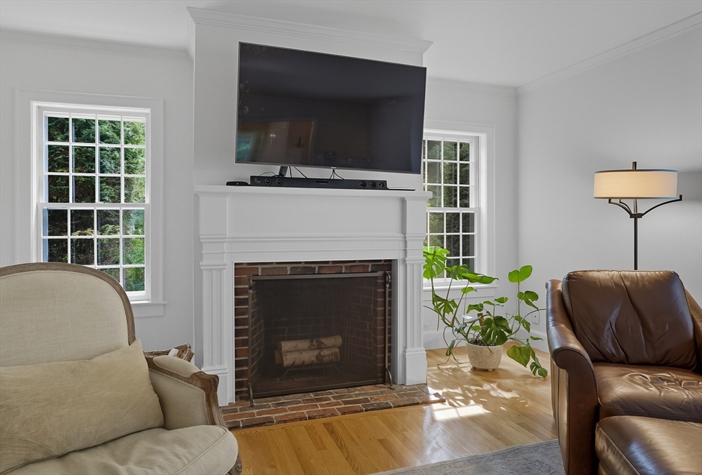 16 Priest Road Berlin, MA 01503 - Photo 16 of 42 a living room with furniture a flat screen tv and a fireplace