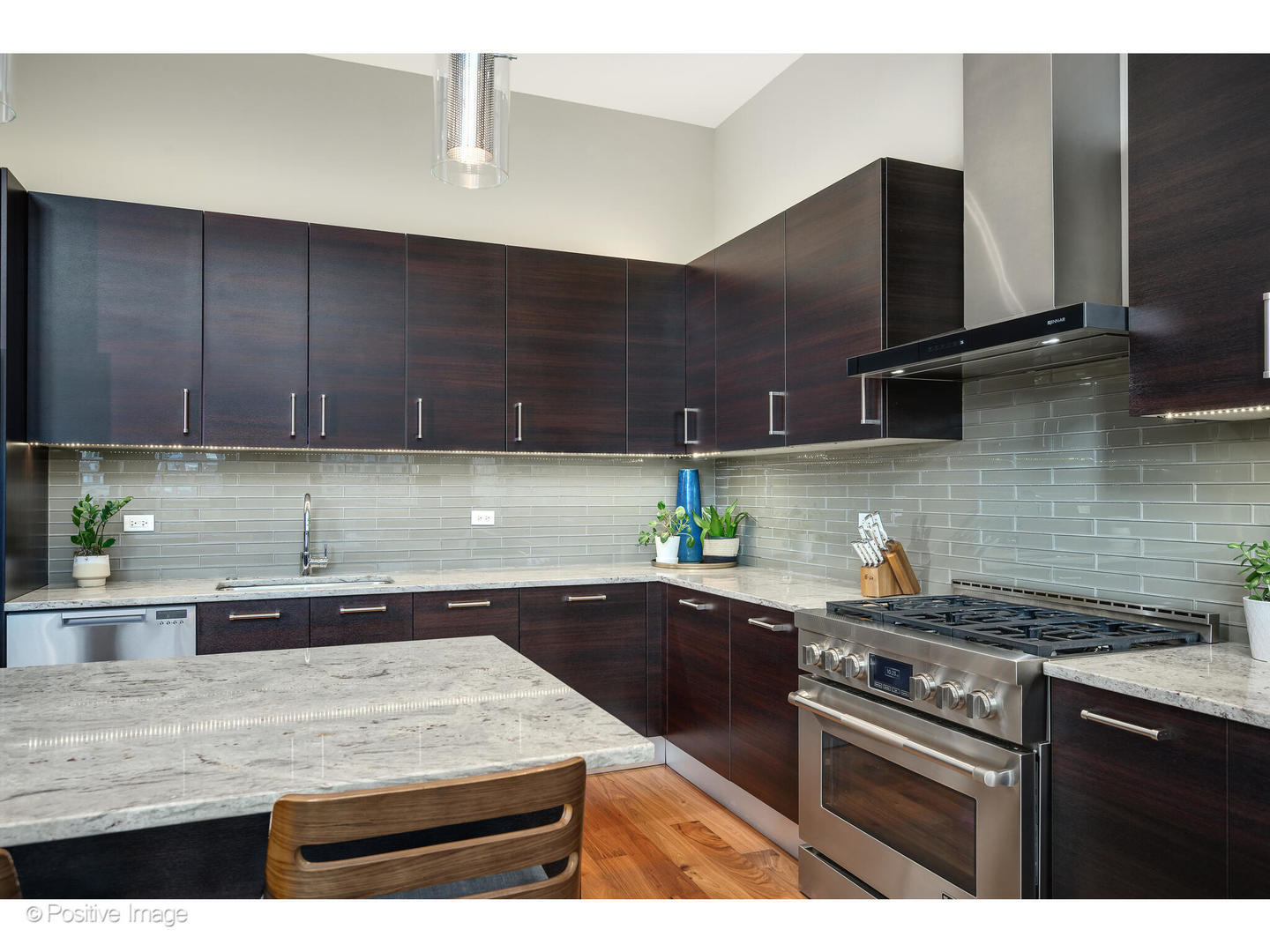 18 North Carpenter Street, Unit PHN Chicago, IL 60607 - Photo 18 of 39 a kitchen with stainless steel appliances granite countertop a sink a stove and cabinets