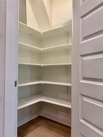 a kitchen with stainless steel appliances granite countertop white cabinets and a stove a oven with white countertops