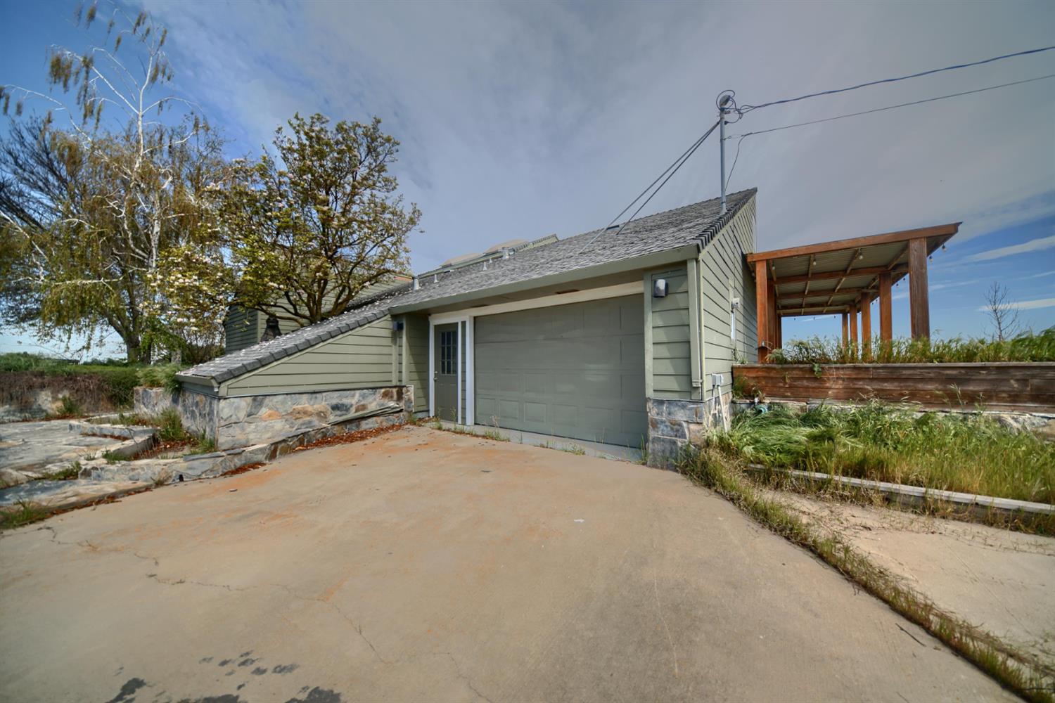 17164 Keyes Road Snelling, CA 95369 - Photo 11 of 97 a front view of a house with a yard and garage