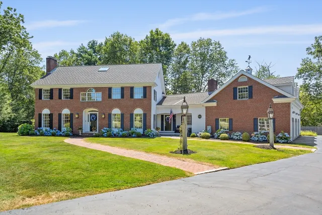 a front view of house with yard and green space