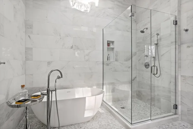 a bath tub sitting next to a shower