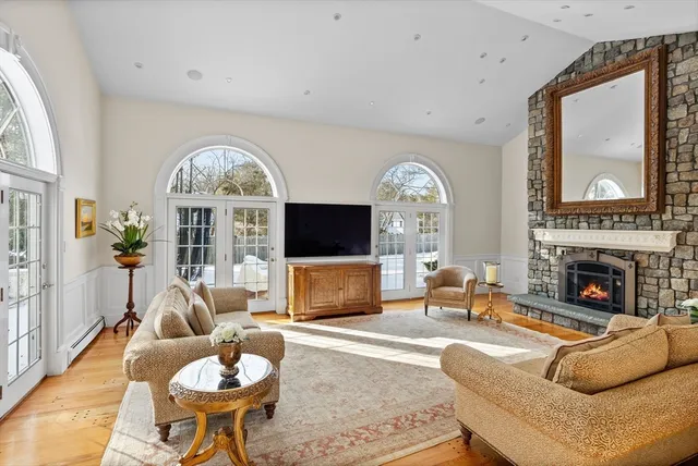 a living room with furniture a fireplace and a flat screen tv