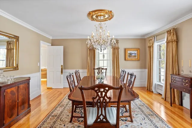a view of a dining room with furniture and a chandelier