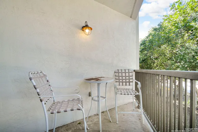 a view of balcony with furniture