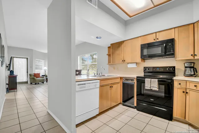 a kitchen with stainless steel appliances granite countertop a stove and a sink