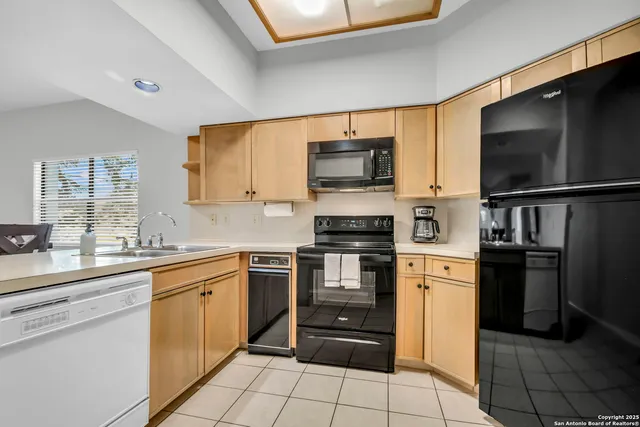 a kitchen with stainless steel appliances a stove microwave and refrigerator