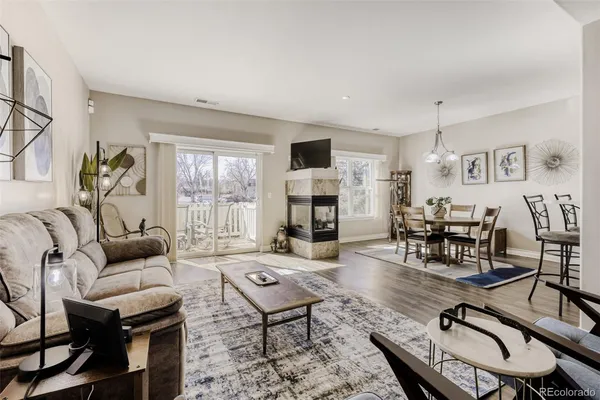 a living room with furniture fireplace and a table