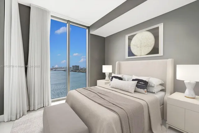 a bedroom with a bed and a lamp on table