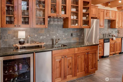 a kitchen with stainless steel appliances granite countertop a sink and cabinets