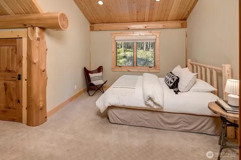 a bedroom with a bed and a table