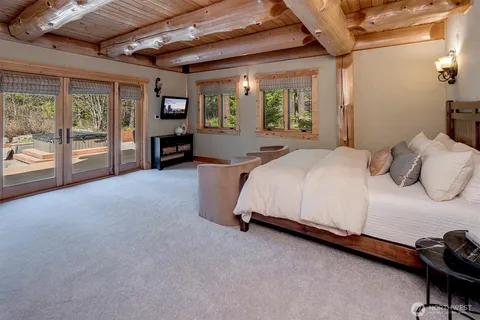 a bed room with a bed and a tv