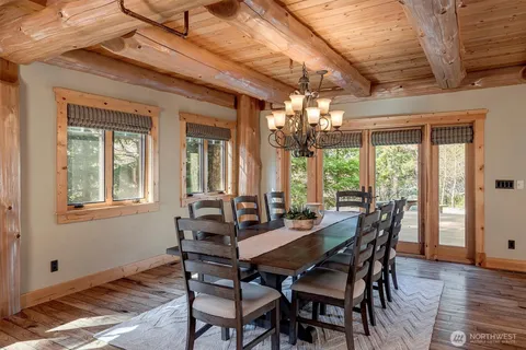 a view of a dining room with furniture wooden floor and chandelier