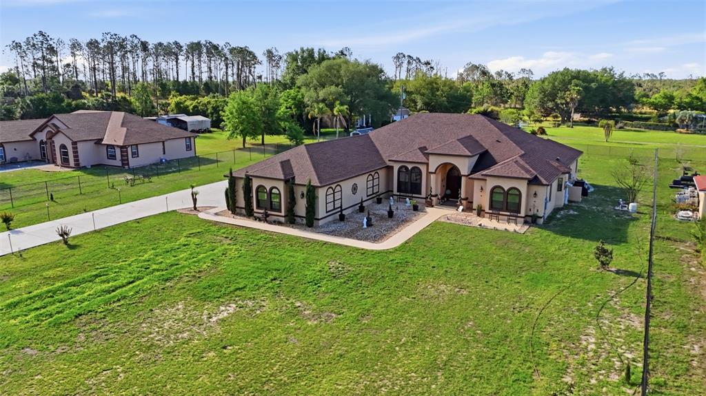 13429 Montevista Road Clermont, FL 34711 - Photo 73 of 89 a aerial view of a house with a big yard