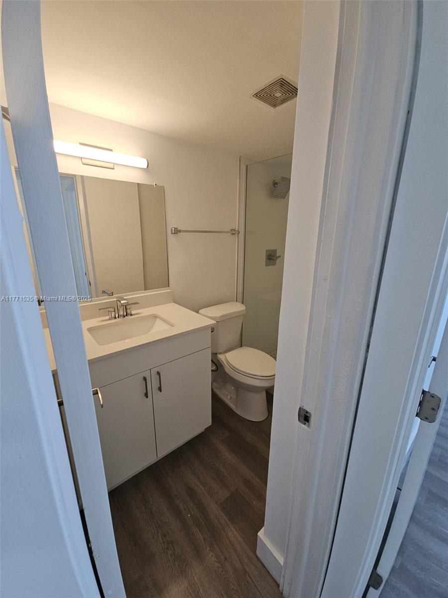 8101 Crespi Boulevard, Unit 304 Miami Beach, FL 33141 - Photo 15 of 25 a bathroom with a sink and a mirror