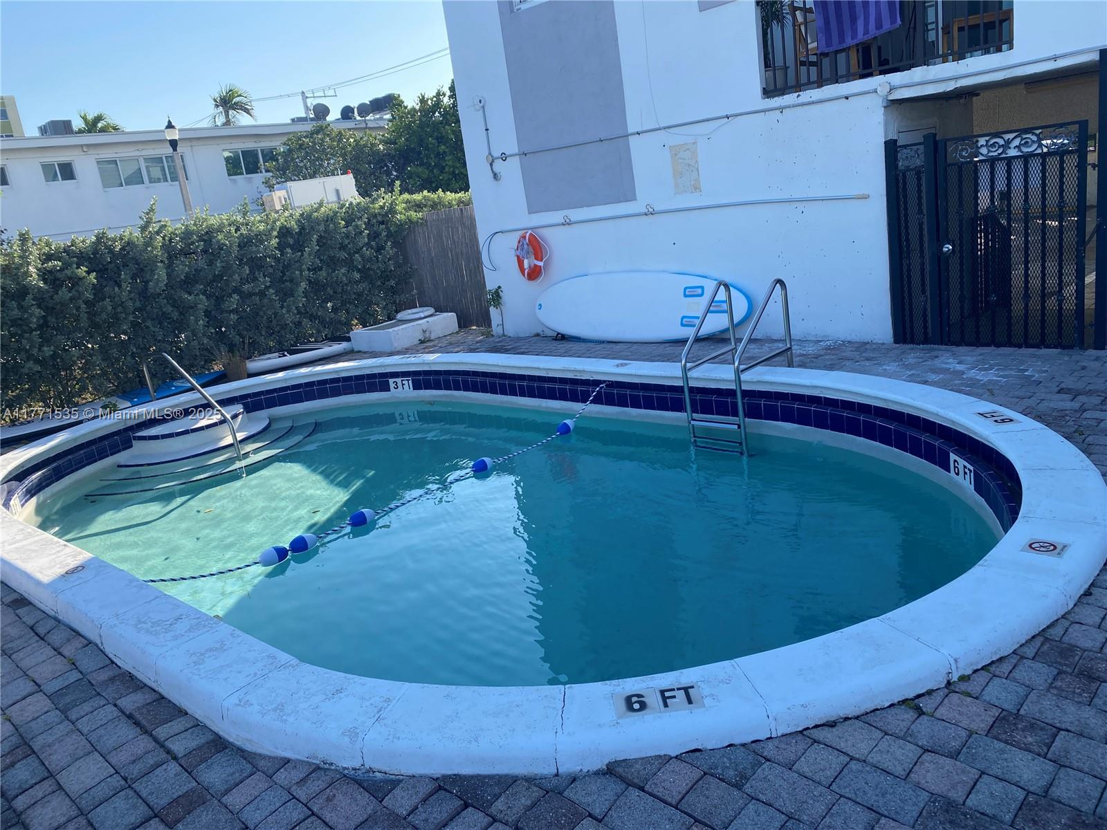 8101 Crespi Boulevard, Unit 304 Miami Beach, FL 33141 - Photo 21 of 25 a view of a swimming pool with a yard