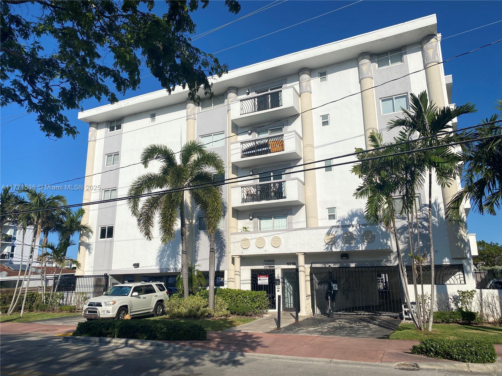 8101 Crespi Boulevard, Unit 304 Miami Beach, FL 33141 - Photo 24 of 25 a front view of a building with parking